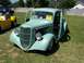 2002 Ford Mustang - A vintage pickup truck is parked on a grassy field next to a yellow sports car.
