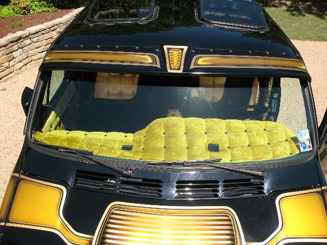 Black van with gold trim, yellow quilted dash cover, and sunroofs