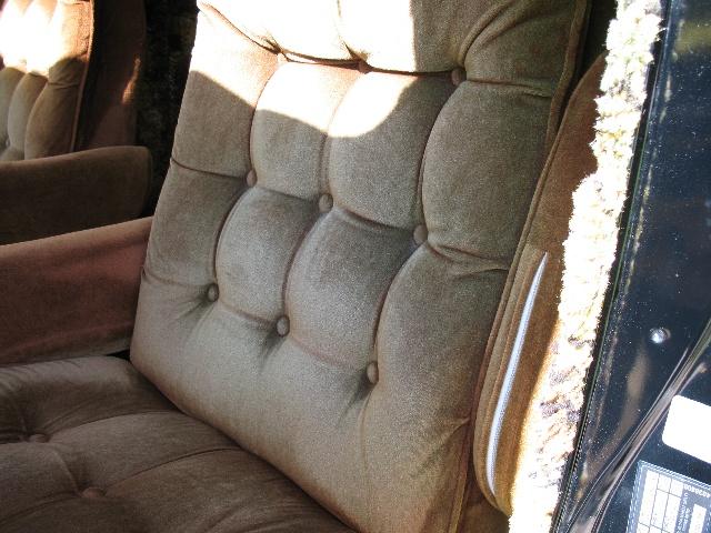 Close-up of brown tufted velour seats inside a vehicle