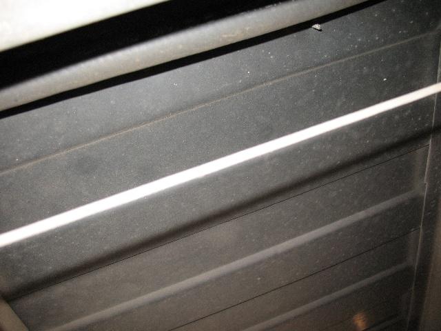 Underside of a vehicle with horizontal ribbed panels