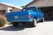 1976 Chevrolet C/K Pickup - This blue pickup truck features flame decals and a custom paint job, parked in a driveway.