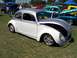 2002 Ford Mustang - Customized Volkswagen Beetle on display at a car show with other classic vehicles.
