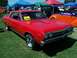 2002 Ford Mustang - A red 1967 Chevrolet Chevelle SS coupe is displayed outdoors under tents at a car show.