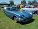 2002 Ford Mustang - A blue 1958 Ford Thunderbird is parked on the grass at an outdoor car show with other vehicles in the background.