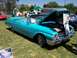 2002 Ford Mustang - A turquoise 1959 Ford Fairlane convertible is displayed with its hood open at an outdoor event.