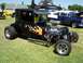 2002 Ford Mustang - A custom hot rod with a powerful engine and flame decals sits on display at an outdoor event.