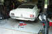 1968 Ford Mustang - A white 1968 Ford Mustang coupe is parked in a garage, with tools laid out on the concrete floor.