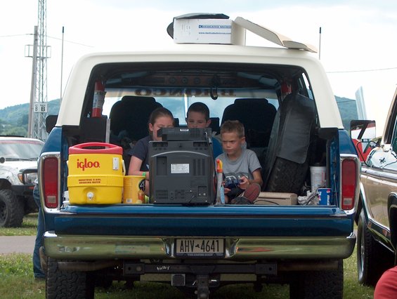 Kids playing video games in the back of Ken's Bronco.
