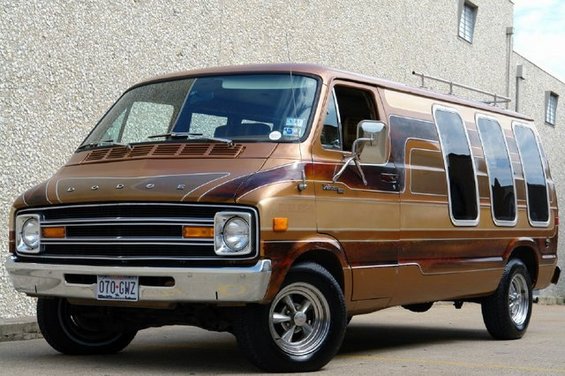 Brown and tan van with custom side windows and chrome wheels, viewed from the front three-quarter angle