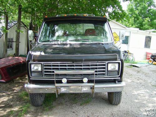 Black 1978 Ford E250 front view with chrome grille and bumper