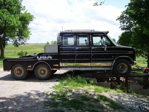 Black 1978 Ford E250 extended cab pickup truck with a dual-rear-wheel flatbed, seen from the side