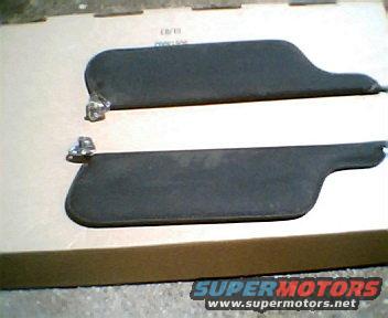Two dark-colored sun visors with metal pivot mounts