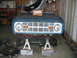 1992 Ford Mustang - The front clip of a blue Ford Bronco is disassembled and supported by jack stands in a garage.