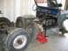 1992 Ford Mustang - A blue Ford Bronco body is shown in a garage during a restoration project, with its wheels removed and interior components visible.