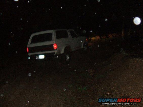 1989 Ford Bronco rear view at night on dirt road