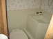 1996 Dodge 2500 - Bathroom interior with toilet and bathtub, wallpaper on the wall.