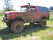 1989 Ford Bronco - This red 1989 Ford Bronco is heavily coated in mud, equipped with a snorkel and large off-road tires, suggesting it has been used for off-r…