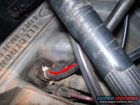 Close-up of engine component with 'ELECTRONIC FUEL INJECTION' text