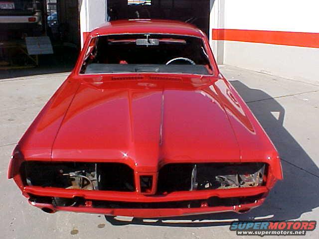 Red 1967 Mercury Cougar front view, missing headlights