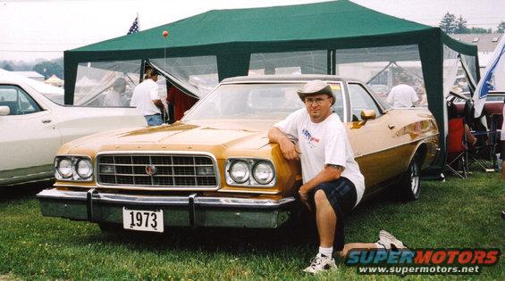 Gold 1973 Ford Ranchero with a man posing next to it