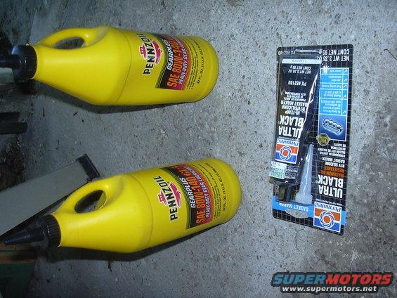 two bottles of Pennzoil gear oil and a tube of Permatex Ultra Black gasket maker on a concrete floor