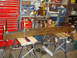 1989 Ford Bronco - A long, rusty metal beam is clamped and supported by sawhorses in a garage setting.