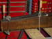 1989 Ford Bronco - Metal beam being worked on, clamped to a workbench with red tool chests visible.