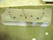 1996 Dodge 2500 - A gray plastic bumper part with wiring and a red light is shown on a green floor.
