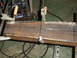 1989 Ford Bronco - Metal beam clamped in place for welding, with a welding machine visible.