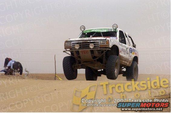1992 Ford Explorer racing in desert, front 3/4 view