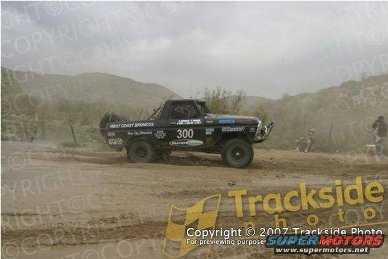 Black off-road racing truck with number 300 and "West Coast Broncos" text