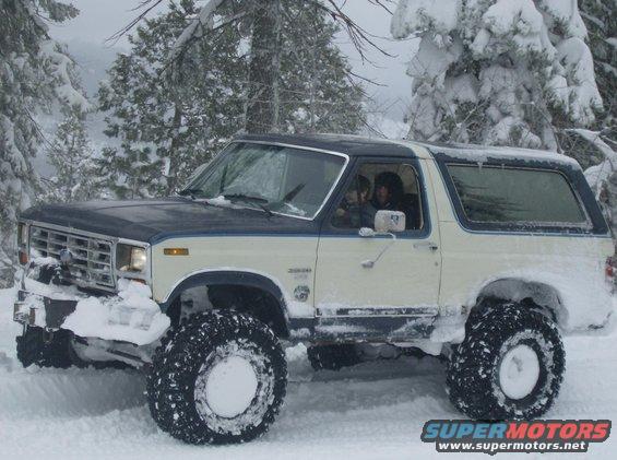1986 Ford Bronco in snow, lifted with large tires
