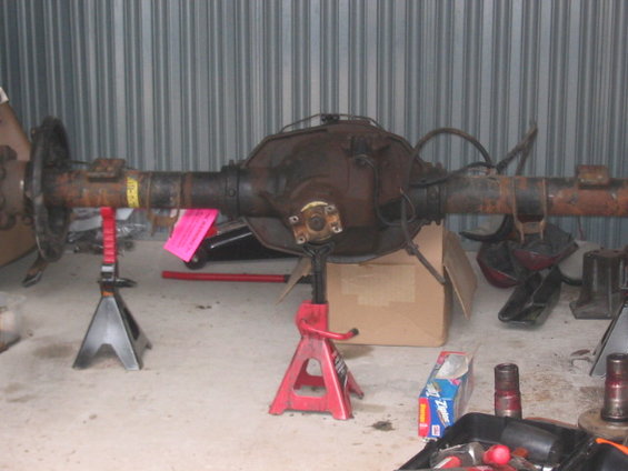 Rear axle assembly on jack stands, with yellow and pink tags