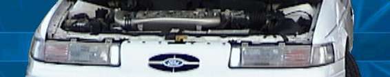 1993 Ford Taurus engine bay with hood open, showing engine and front grille