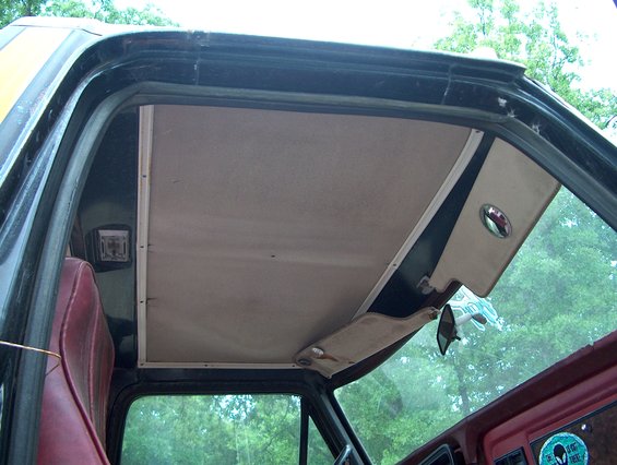 Interior view of a 1979 Ford Bronco showing the headliner and sun visor