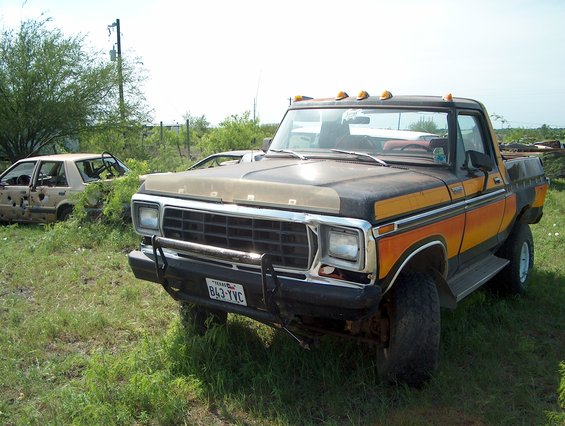 1979 Ford truck with orange and yellow stripes, front 3/4 view
