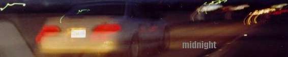 Rear of a car at night with taillights illuminated and a license plate