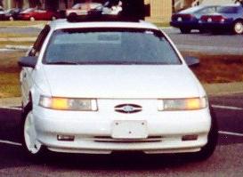 Front view of a white 1993 Ford Taurus parked outside