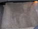 1995 Ford Taurus - The interior floor carpet of a vehicle is visible, showing a gray, textured surface.