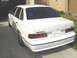 1995 Ford Taurus - 1995 Ford Taurus SHO sedan seen from the rear, parked in a driveway.