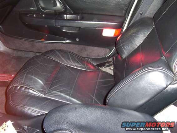 Interior shot of black leather car seats and door panel