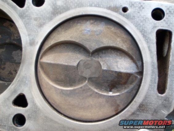 Close-up of an engine piston inside a cylinder head