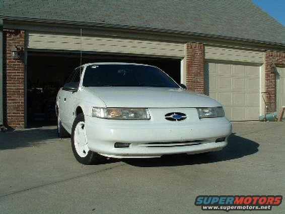 1993 Ford Taurus parked in front of a garage