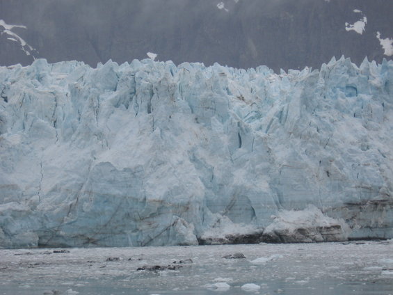 Glacier face with icebergs in foreground water