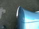 1970 Ford Ranchero - A close-up shot focuses on the curved fender and chrome accent of a blue vehicle.