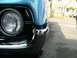 1970 Ford Ranchero - Close-up of a blue 1968 Ford Ranchero's front corner, showing the headlight and chrome bumper.