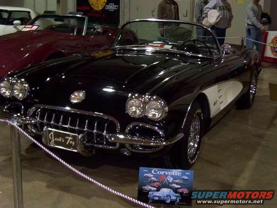 Black 1958 Chevrolet Corvette convertible with white side accents, chrome grille, and a "Jack's Toy" plate