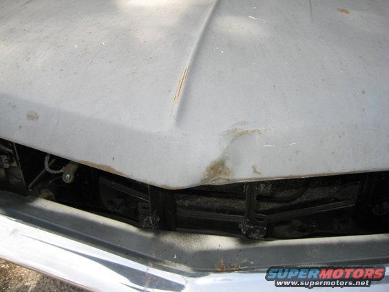 close up of dent in hood