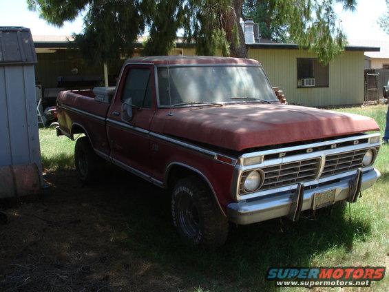 1977 Ford F-150 pickup truck, red, parked in a yard