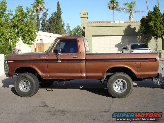 Side view of a brown 1977 Ford F-150 pickup truck parked on a street